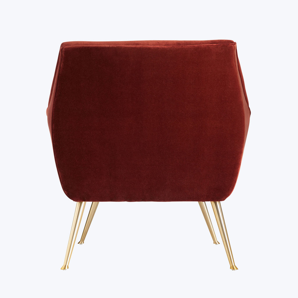 Contemporary red velvet chair with gold legs exudes elegance and style