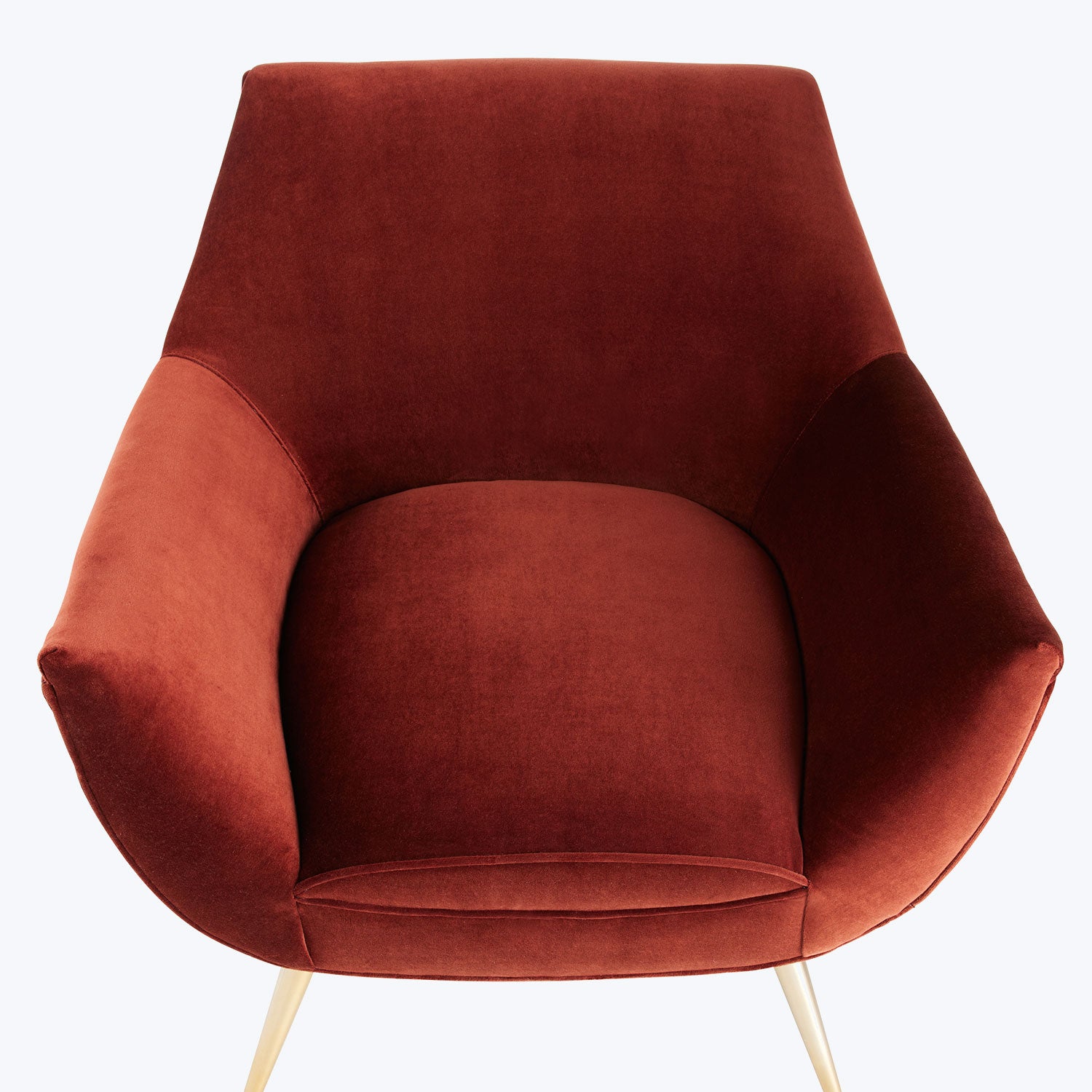 Modern armchair with elegant design and luxurious terracotta upholstery.