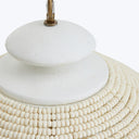 Close-up of textured white object with decorative elements and metallic fixture