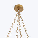 Brass ceiling mount with metallic chains suspending in elegant arrangement.