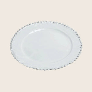 Elegant white plate with textured edge design on white background.