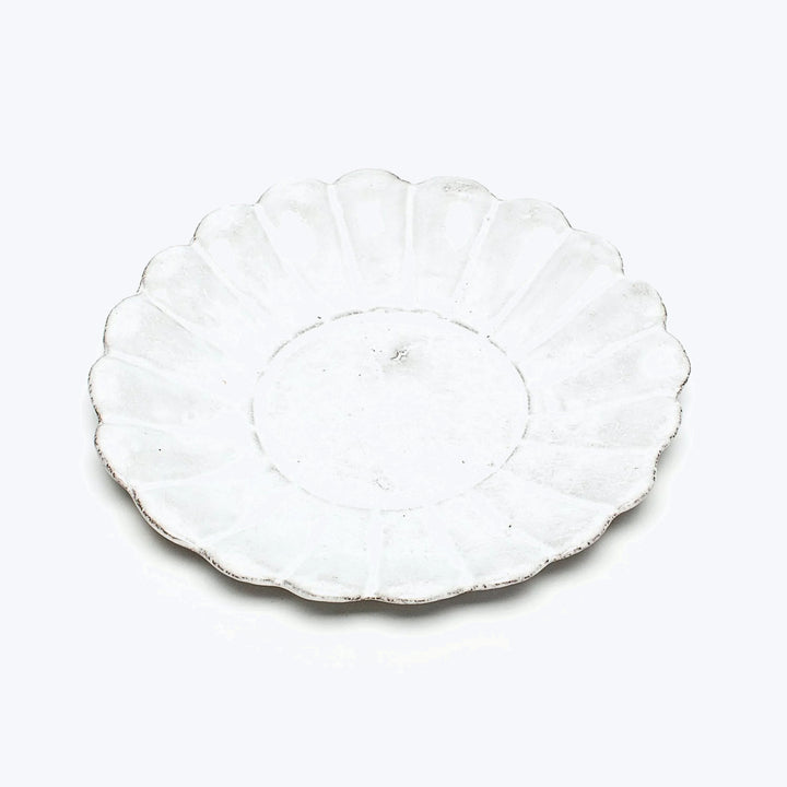 Vintage white scallop-edged plate with radial pattern, handmade look.
