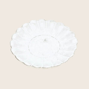 Vintage white scallop-edged plate with radial pattern, handmade look.