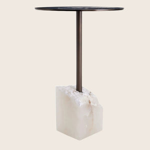 Contemporary side table with dark round top, metallic support, stone base. - hover