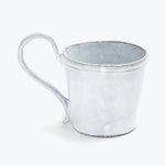 Rustic metal cup with handle, ideal for outdoor activities.