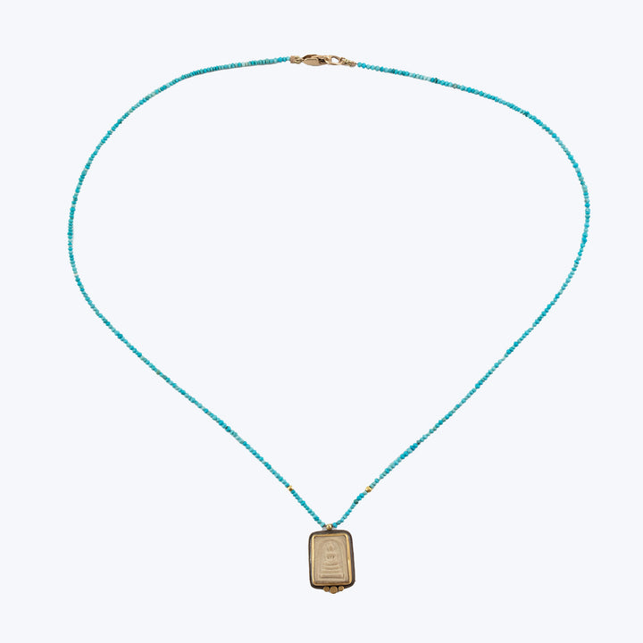 Delicate turquoise bead necklace with gold pendant and clasp.