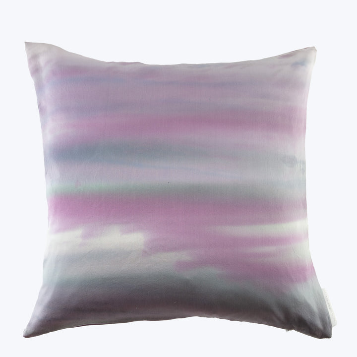 Square pillow with tie-dye pattern in purple, pink, and grey.
