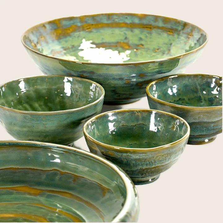 Handcrafted ceramic bowls with rustic glaze finish in varying sizes.