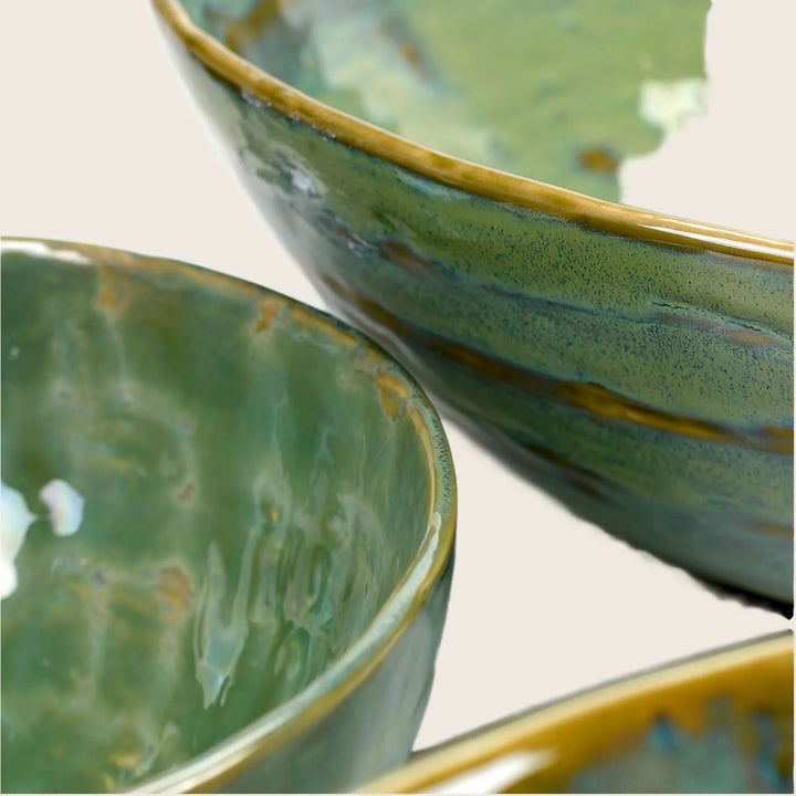Three ceramic items with unique green glaze finishes on display.