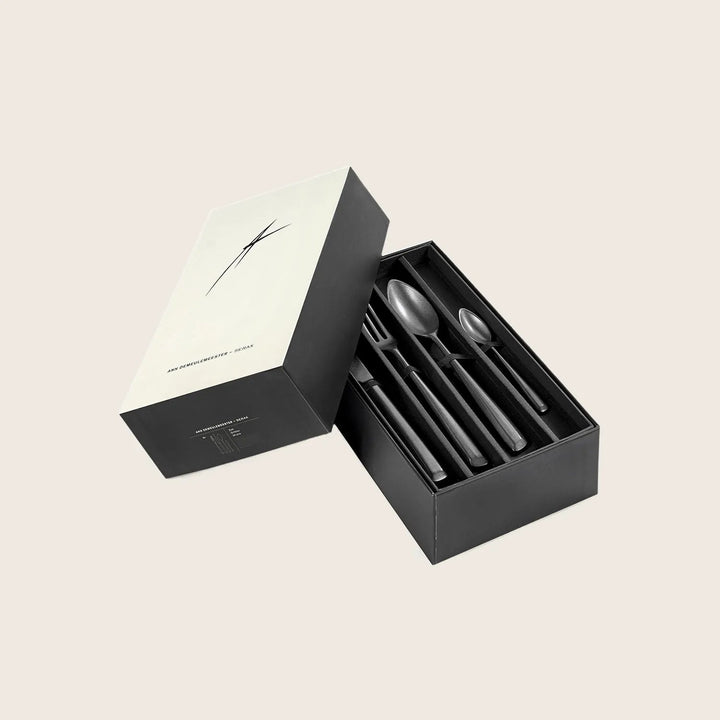 Sophisticated cutlery set in modern box, perfect for dining and dessert.