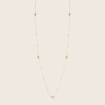 Elegant gold necklace with intricate design and textured details.