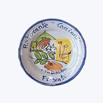 Decorative ceramic plate with hand-painted design from Ristorante Gacciani.