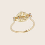 Luxurious gold ring with seashell design and diamond accents.