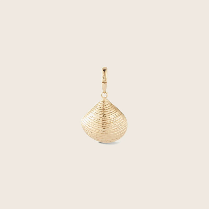 Gold teardrop pendant with ribbed texture on neutral background