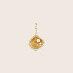Elegant gold-tone pendant with pearl, diamonds, and modern design.