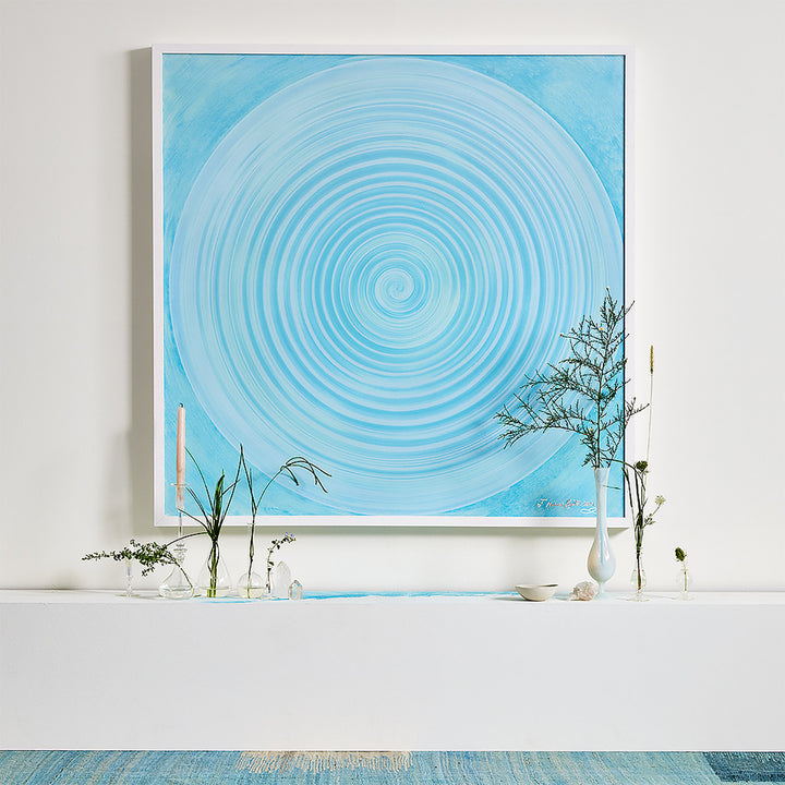 Minimalist interior with a mesmerizing artwork, green plants, and serene ambiance.