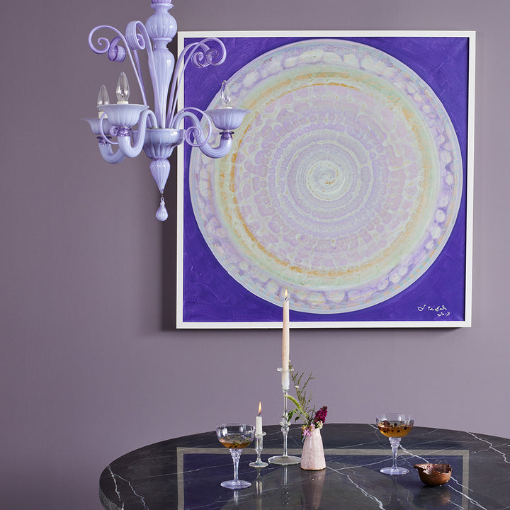 An elegant interior setting with a stylish artwork and chandelier.