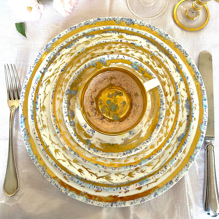 Elegant table setting with decorative plates, utensils, and glassware.