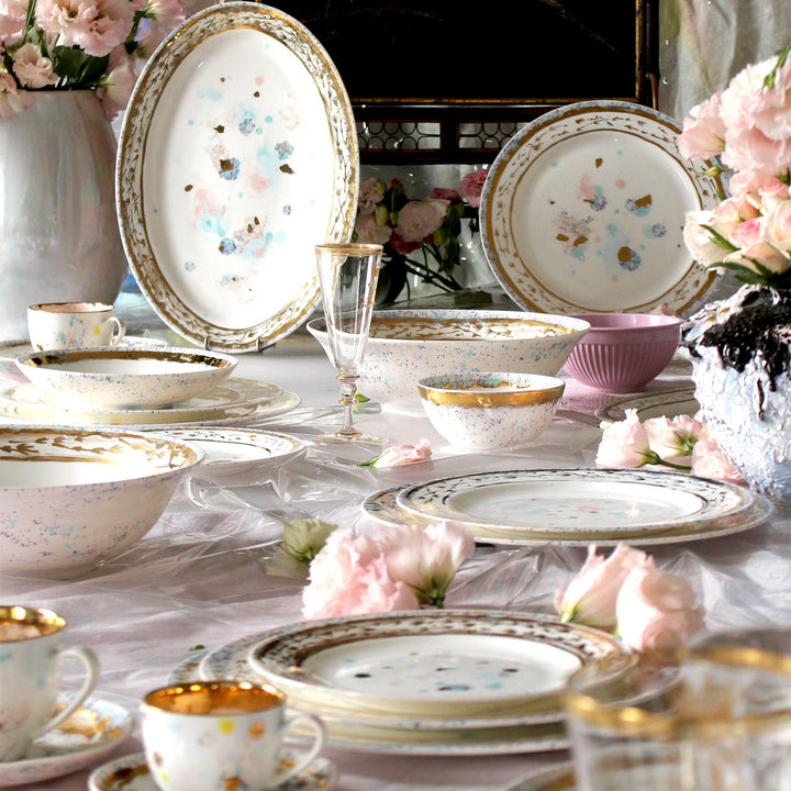 Elegantly arranged table setting with floral dinnerware and glassware.
