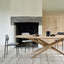 Minimalist dining space with a modern wooden table and complementary chairs.