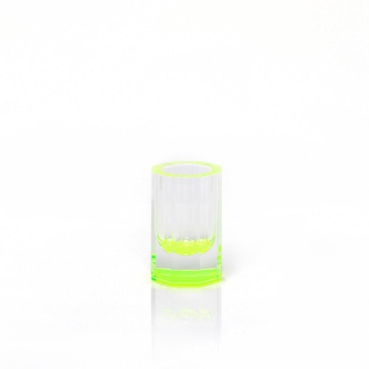 Minimalist glass with neon green accents on reflective surface.