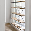 Minimalist shelving unit with ceramic items and natural light ambiance.