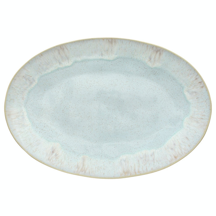 Oval ceramic plate with speckled design in light blue/aqua color.