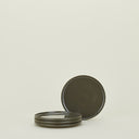 Two metallic tin pieces with ridged edges, separated and unattached.