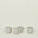Minimalist cream mugs with metallic glazed interiors create elegant simplicity.