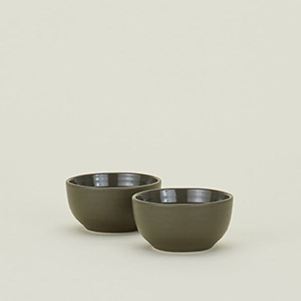 Two olive green bowls with contrasting matte and glossy finishes.
