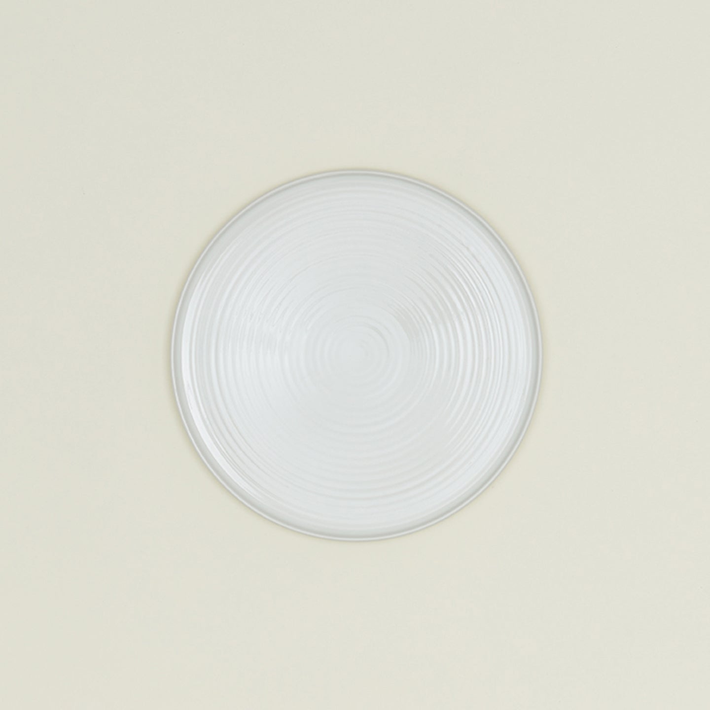 Minimalistic ceramic plate with a captivating concentric pattern design.