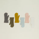 Five pairs of textured gloves in various colors neatly arranged.