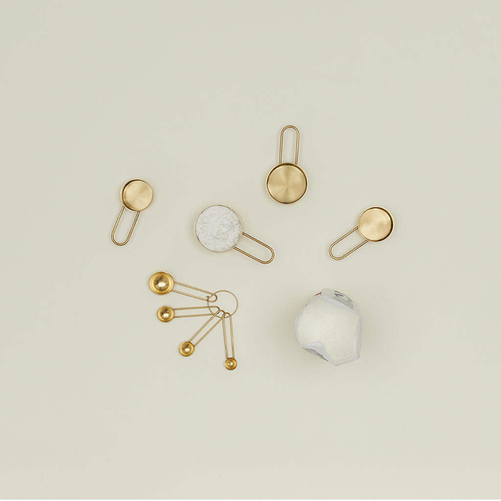 An artistic arrangement of metallic decorative objects with a golden palette.