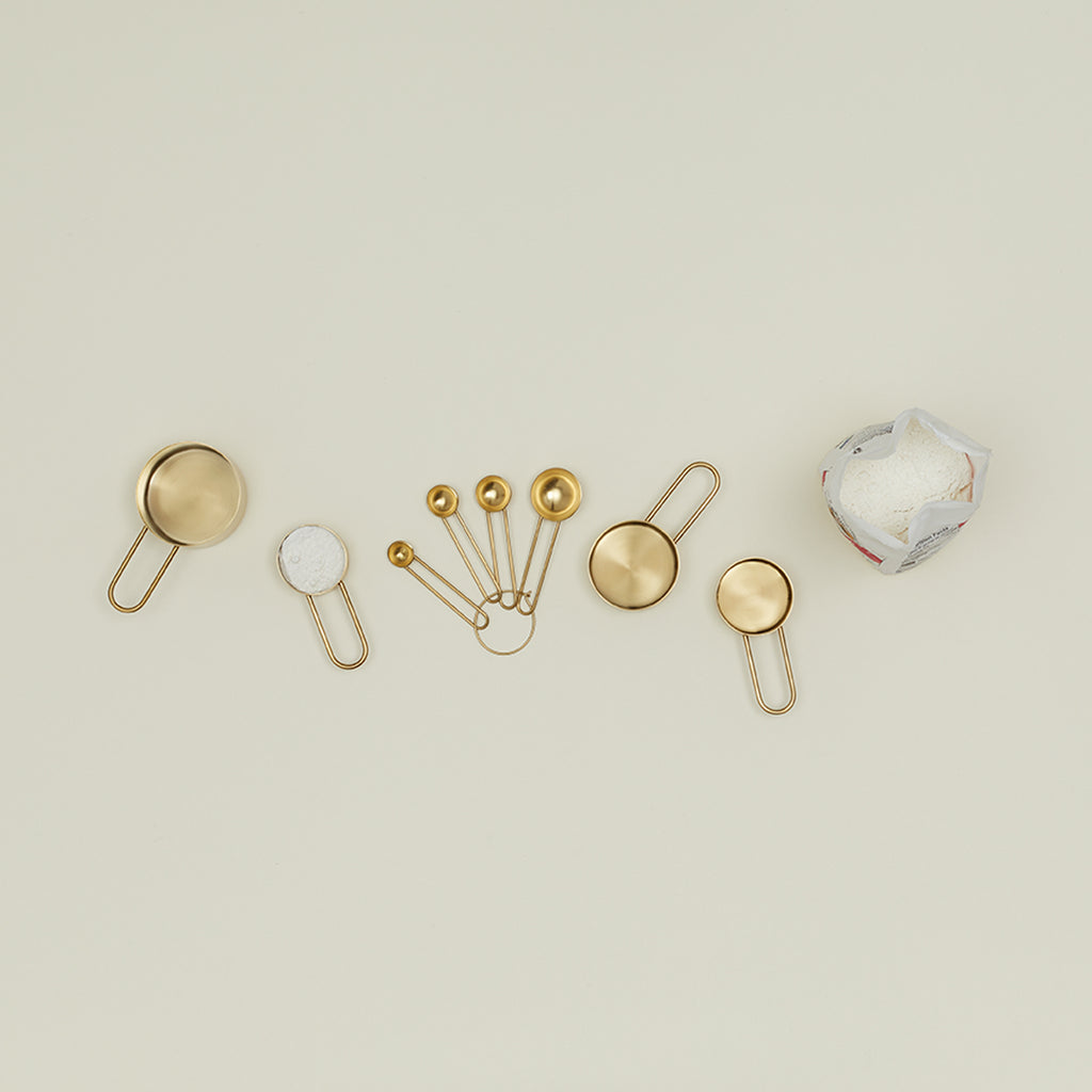 An elegant assortment of metallic objects against a minimalistic background.