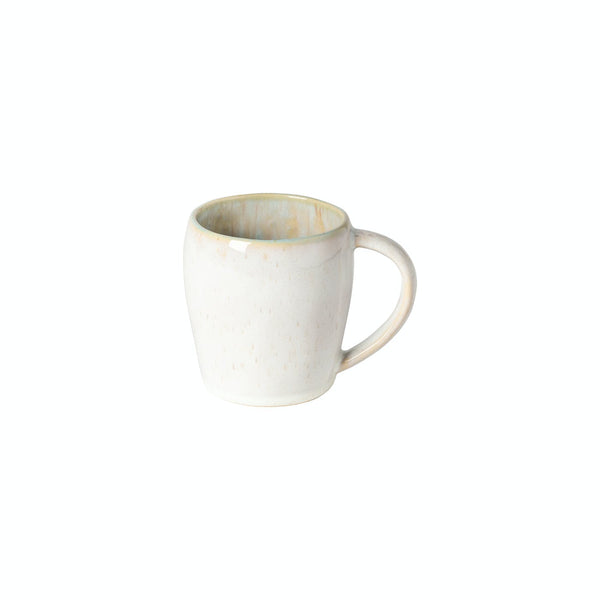 Light-colored ceramic mug with speckles and yellowish interior on white background.