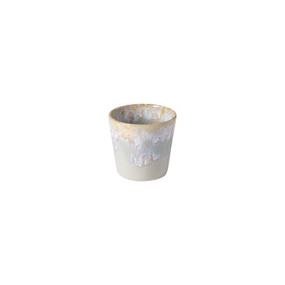 Handmade ceramic cup with textured rim and rustic golden hues.