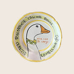 Decorative plate with cartoon goose illustration and restaurant name text.