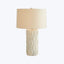 Contemporary table lamp with elegant white base and neutral shade.