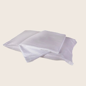 Two folded pillowcases in pink and white against white background. - hover