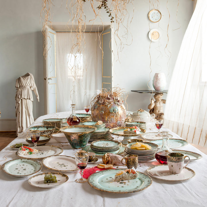Eclectic bohemian dining table with mismatched plates and whimsical decor.