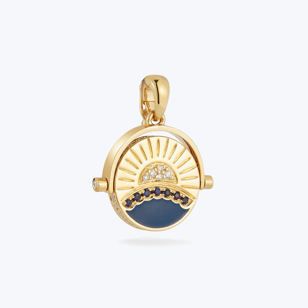 Nautical-themed gold pendant with blue enamel and gemstones detailing.