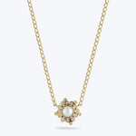 Gold pendant necklace with pearl and diamond flower centerpiece design.