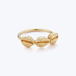 Elegant gold ring with intricate shell-like design on polished band.