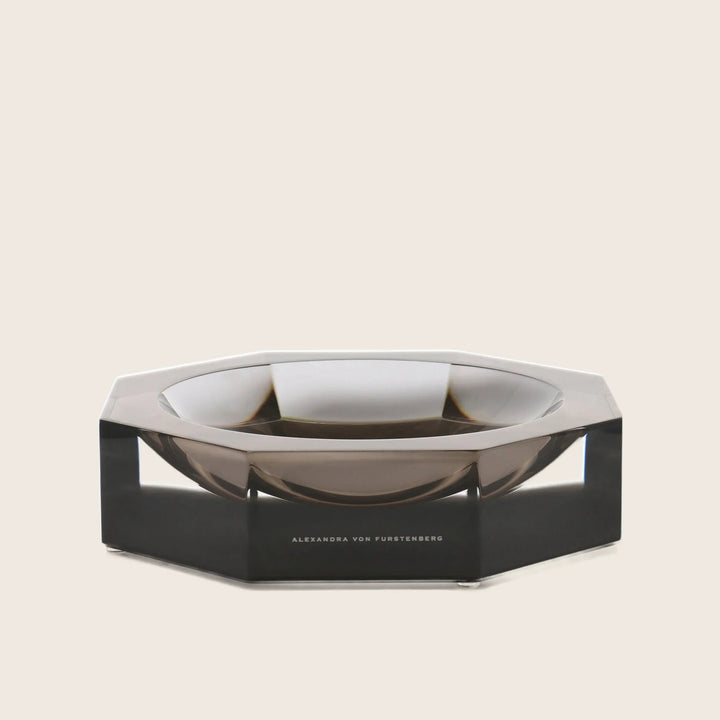 Modern, transparent ashtray with sleek design and jewel-like aesthetics.