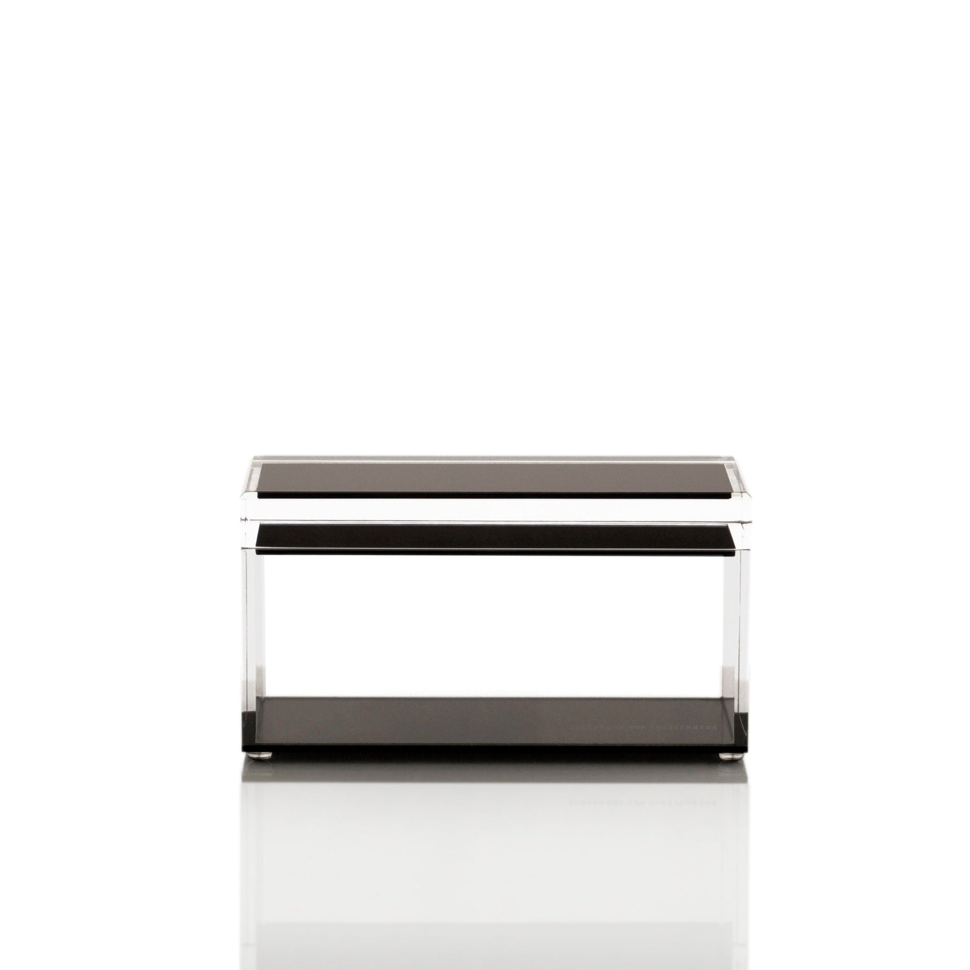 Minimalist coffee table with sleek black top and chrome accents