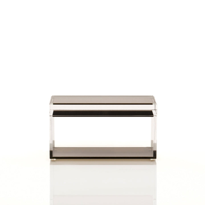 Modern transparent object with metallic edges against bright background.