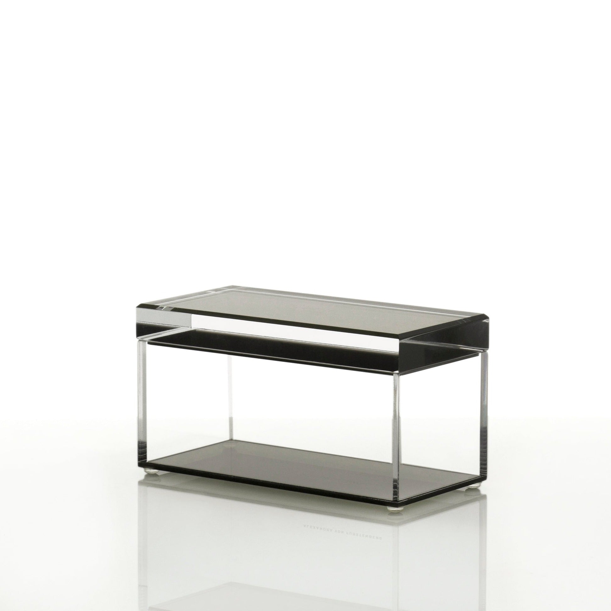 Modern, minimalist side table with sleek black frame and glass surfaces.