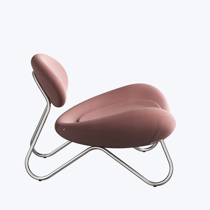 Modern lounge chair with ottoman in light brown fabric upholstery.