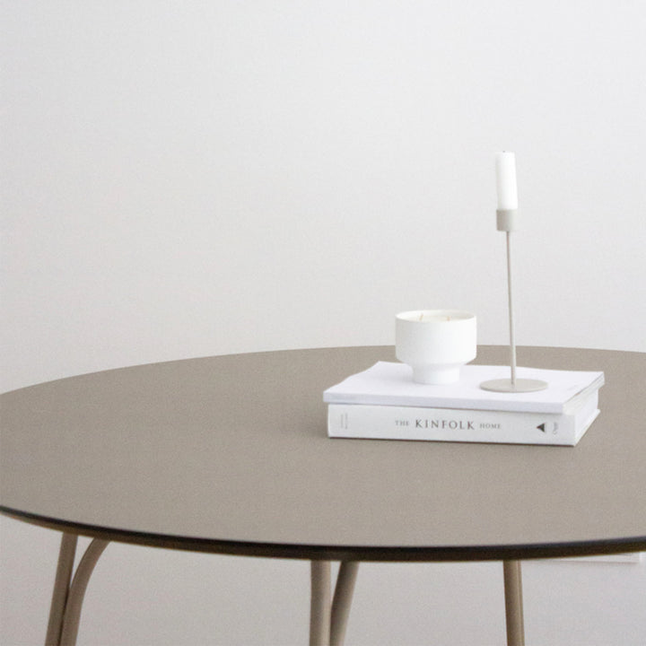 Minimalist interior scene with round table, THE KINFOLK HOME book.