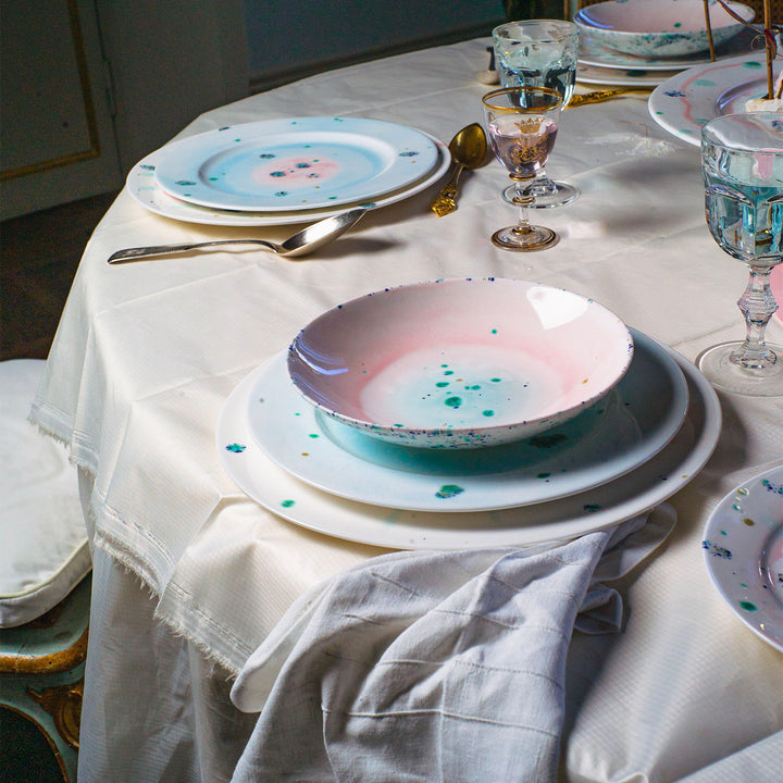 Artistic and modern dining table setting with eclectic tableware mix.